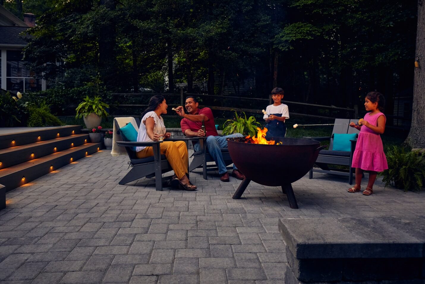 family enjoying fire pit on patio